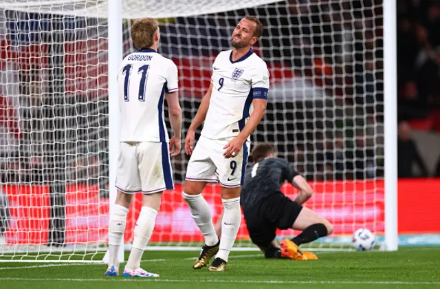 Harry Kane of England (R) reacts alongside teammate Anthony Gordon