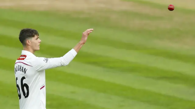 Archie Vaughan shapes to catch a ball thrown to him