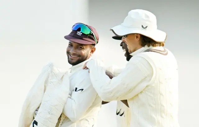 Shakib Al Hasan, Kemar Roach and Tom Curran of Surrey interact