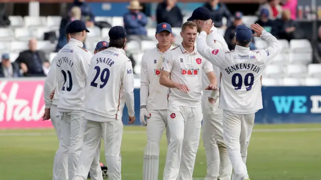 Jamie Porter of Essex celebrates with his team mates after taking the wicket of Joe Clarke