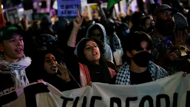 Pro-Palestinian protesters hold a banner outside the venue of the debate between Republican presidential nominee and former U.S. President Donald Trump and Democratic presidential nominee and U.S. Vice President Kamala Harris in Philadelphia