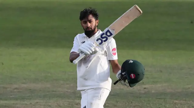 Haseeb Hameed of Nottinghamshire raises his bat after reaching his century