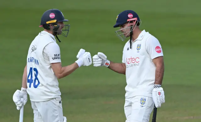 Durham batsman David Bedingham (R) and Colin Ackermann touch gloves during their 400 run partnership