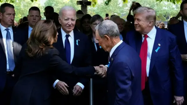 Kamala Harris shakes hands with Donald Trump as Joe Biden and Michael Bloomberg look on