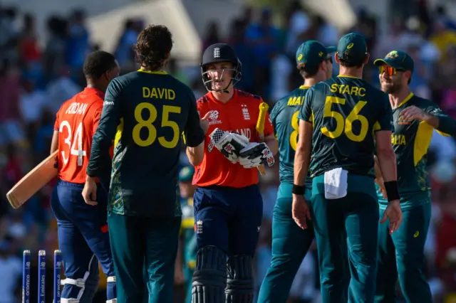 England and Australia's players shake hands at the end of their T20 World Cup match in June