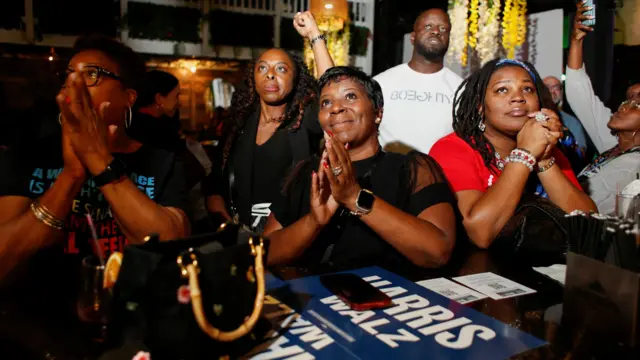 Patrons watch the presidential debate watch party at the black-owned 7th + Grove restaurant in Tampa