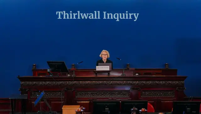 Lady Justice Thirlwall sits below a sign which says Thirlwall inquiry