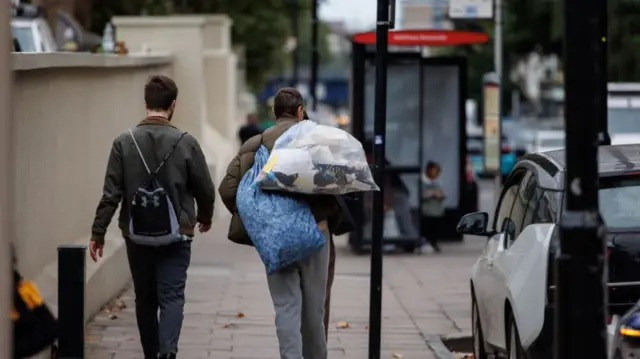 Former prisoners pictured walking carrying their belongings