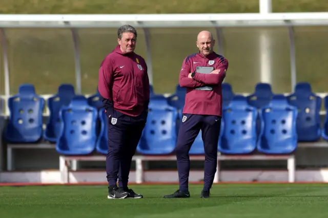 Lee Carsley talks to John McDermott, England Technical Director, during a training session at St George's Park