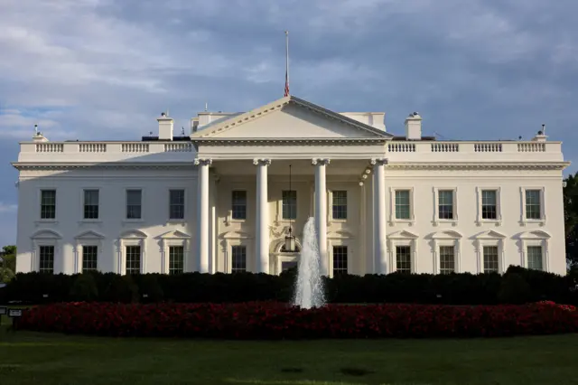 White house with fountain in front