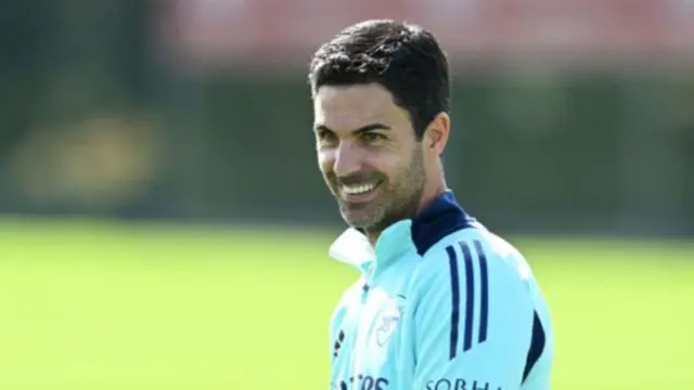 Arsenal manager Mikel Arteta smiling at training