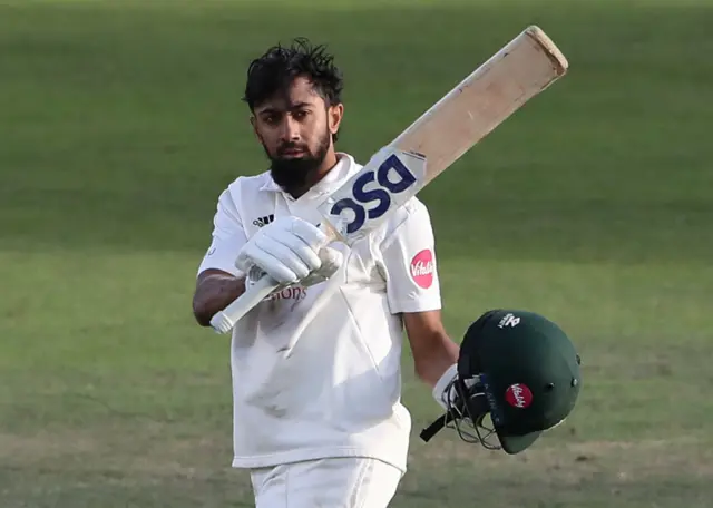 Haseeb Hameed raises his bat after scoring a century against Essex