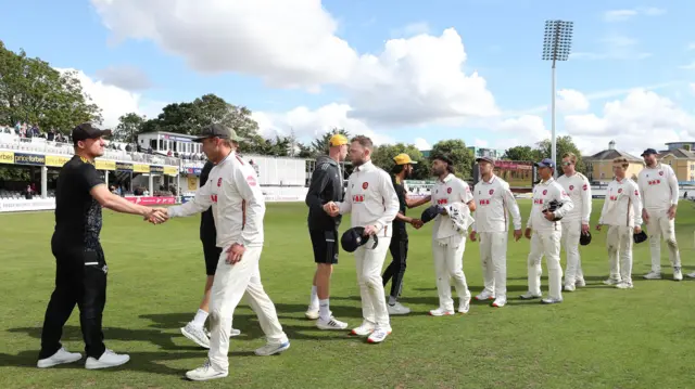 The victorious Essex team leaves the field