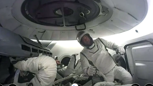 Astronauts suited up inside cabin of spacecraft on Polaris Dawn mission