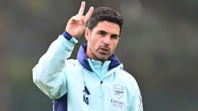 Arsenal manager Mikel Arteta holding two fingers up