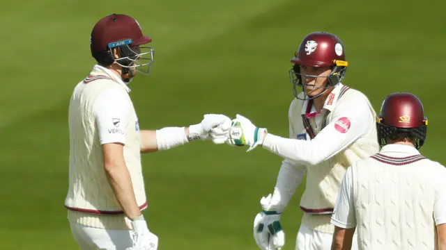 Tom Banton and Craig Overton fist-bump with runner Tom Lammonby