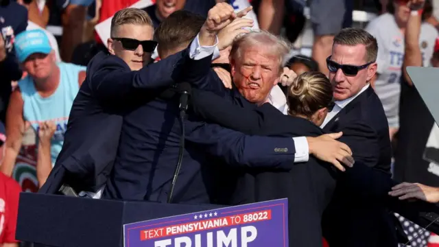 Donald Trump raises his fist after being shot at in Pennsylvania