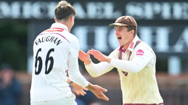 Archie Vaughan of Somerset celebrates the wicket of Ryan Patel