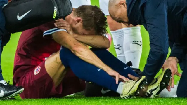 Martin Odegaard sat down receiving treatment after getting injured while playing for Norway