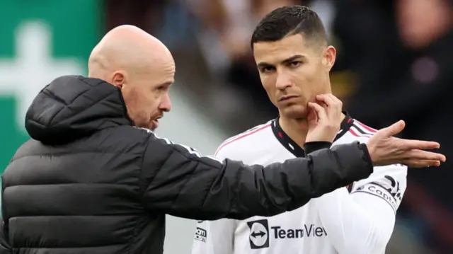 Manchester United manager Erik ten Hag speaking to Cristiano Ronaldo