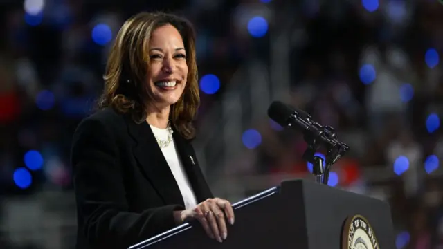 Kamala Harris smiles during a campaign rally in Charlotte, NC