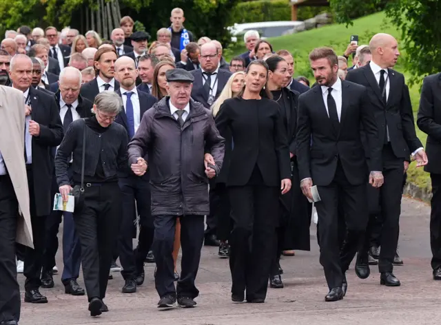 David Beckham, Sven-Goran Eriksson's daughter Lina and his former assistant Tord Grip lead a procession of mourners from Fryksande church in Torsby, Sweden