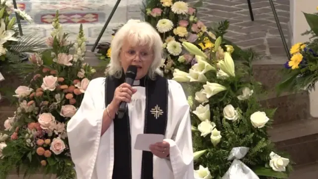 One of the priest leading today's service performs for the congregation