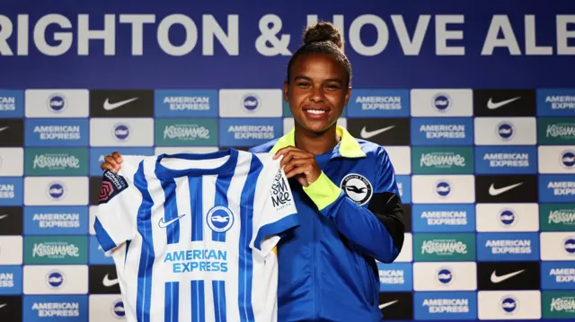 Nikita Parris holds a Brighton shirt