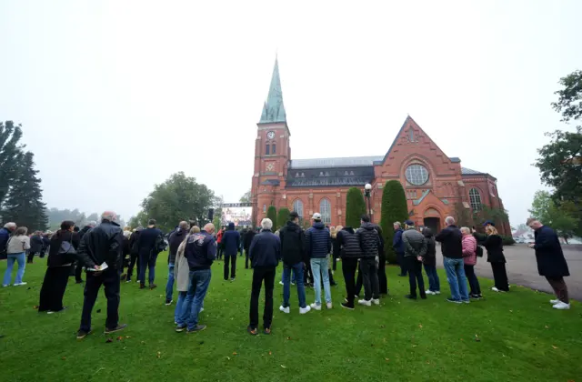 Mourners have assembled on the lawn of the Fryksande Church