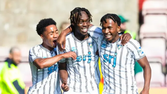 Dunfermline's Ewan Otoo (C) celebrates scoring to make it 1-0 with teammates Kane Ritchie-Hosler (L) and Kieran Ngwenya (R) during a William Hill Championship match between Dunfermline Athletic and Ayr United at KDM Group at East End Park, on August 31, 2024, in Dunfermline, Scotland. (Photo by Ewan Bootman / SNS Group)