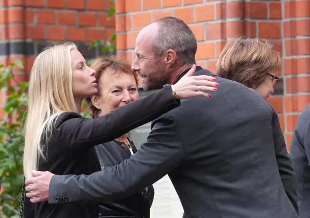 Eriksson's son Johan greets guests outside the church