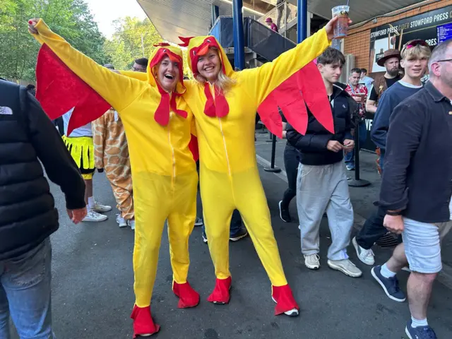 Two women dressed up as hens