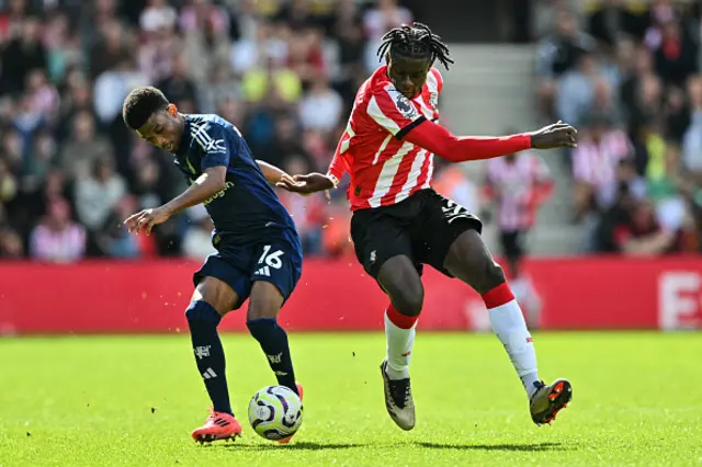 Amad Diallo (L) fights for the ball