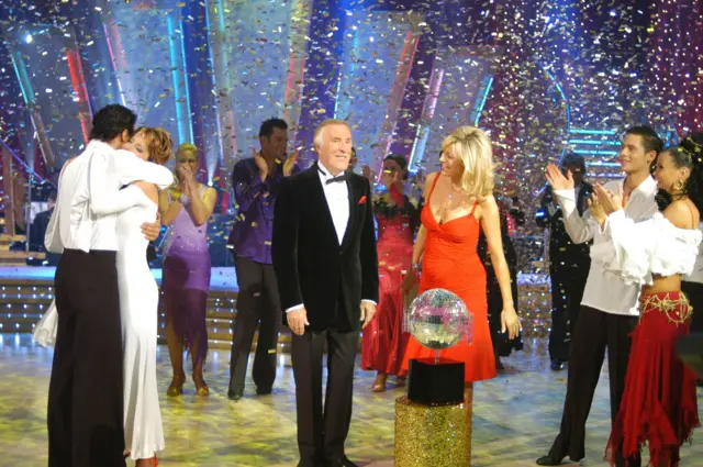 Brendan Cole and Natasha Kaplinsky (2004 winners) hug as Bruce Forsyth, Tess Daly look on and Hanna Karttunen and Christopher Parker clap