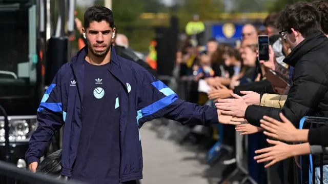 Manor Soloman clapping hands with fans as he walks into the stadium