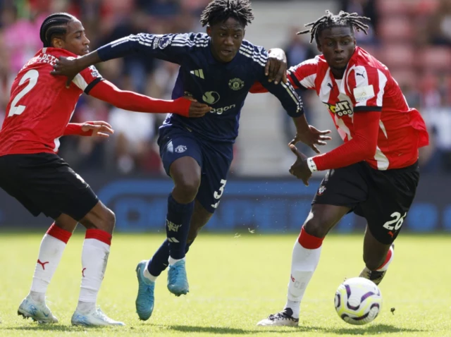 Manchester United's Kobbie Mainoo in action with Southampton's Kyle Walker-Peters