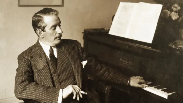 Italian composer Giacomo Puccini at the piano