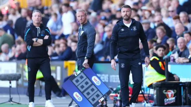 Luton manager Rob Edwards and Millwall manager Neil Harris (left) on the touchline