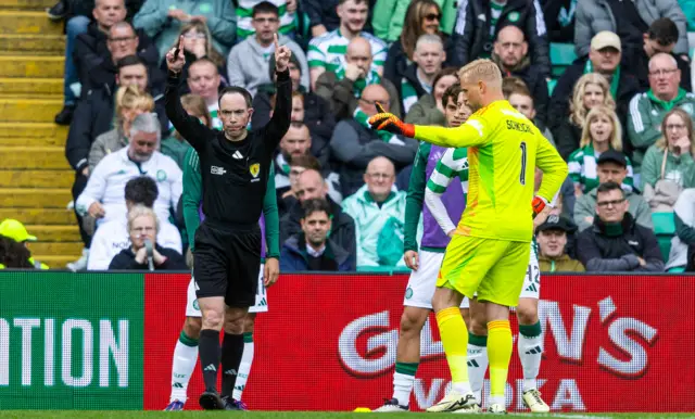 Referee Colin Steven signals a VAR check