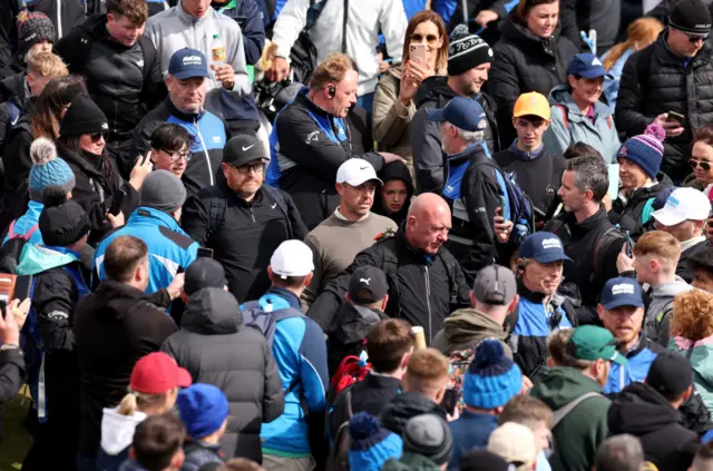 Rory McIlroy wades through the crowd