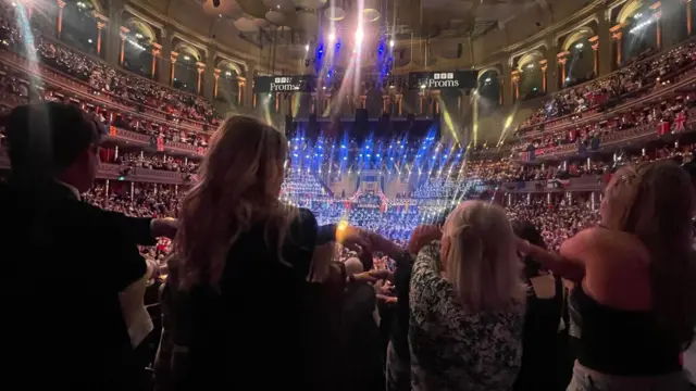 The crowd crosses arms during Auld Lang Syne