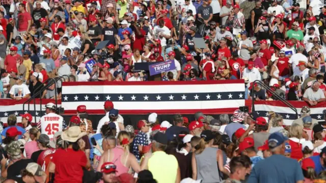 The stunned crowd after Trump is bundled off the stage