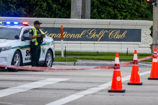 Palm Beach Sheriff officers guard the rear entrance of the Trump International Golf Club