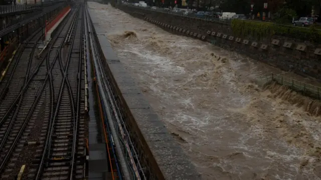 A view of the flooded Wienfluss river channel during heavy rain