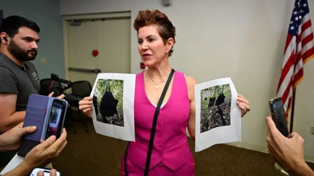 Press Information Officer Teri Barbera shows pictures of evidence found at the fence of US president Donald Trump's golf course, at a press conference in West Palm Beach, Florida, on September 15, 2024 following a shooting incident at former US president Donald Trump's golf course