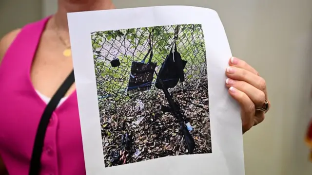 Press Information Officer Teri Barbera shows pictures of evidence found at the fence of US president Donald Trump's golf course, at a press conference in West Palm Beach, Florida, on September 15, 2024 following a shooting incident at former US president Donald Trump's golf course