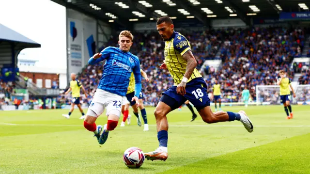 Zak Swanson of Portsmouth and Karlan Grant of West Bromwich Albion