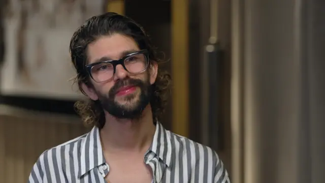 Actor Ben Whishaw wearing a striped shirt