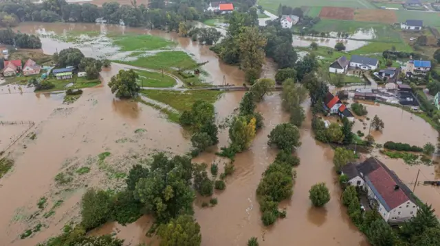 An aerial picture shows a flooded street with brown water after heavy rain in Krosnowice village, southwestern Poland