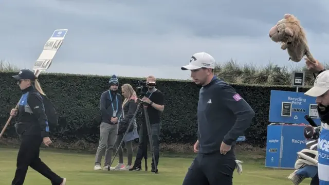 McKibbin walks off the first tee